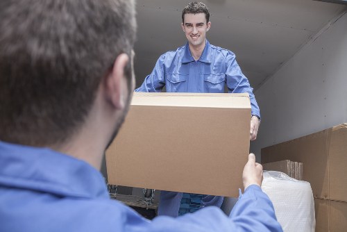 Removal team handling household boxes and furniture in Bayswater