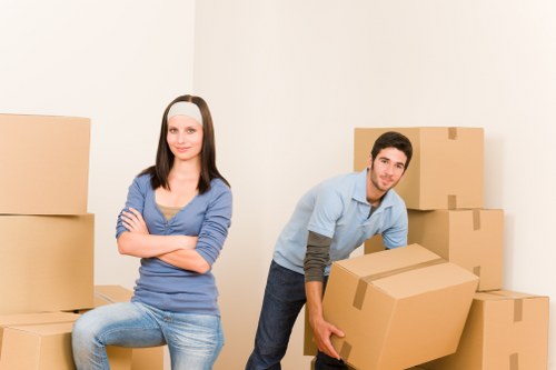 Mover wearing PPE while carrying boxes safely